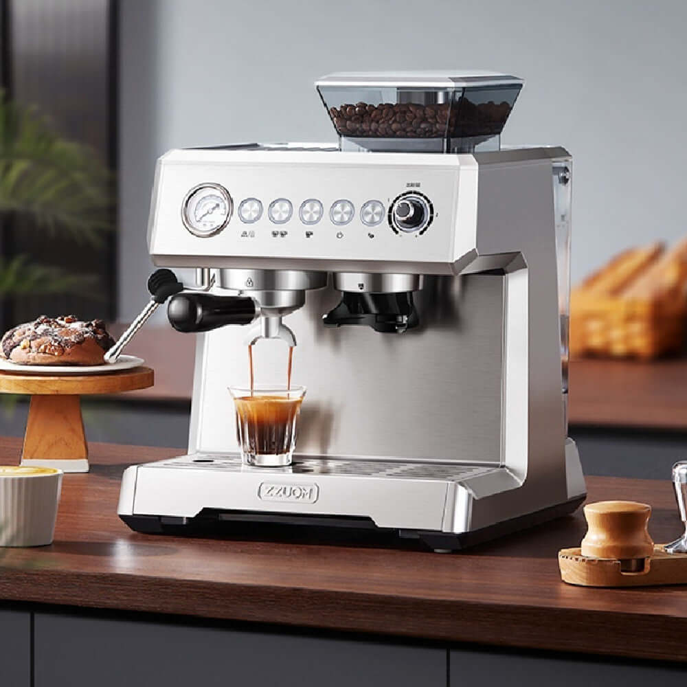 Stainless steel espresso machine brewing coffee on kitchen counter with coffee beans and pastries