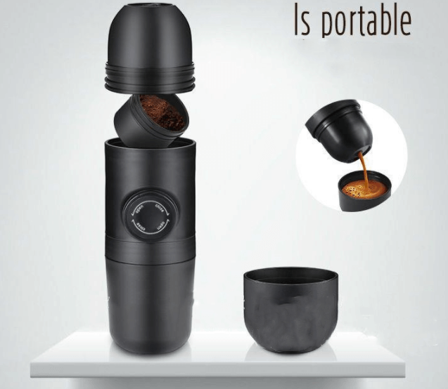 Portable black manual espresso coffee maker with detachable parts and coffee cup on shelf
