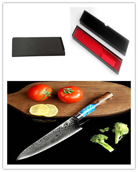 Damascus chef knife with patterned blade, blue resin handle, gift box, and vegetables on a cutting board.