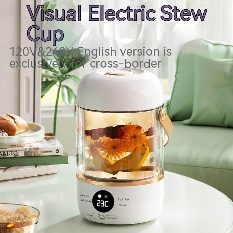 Electric stew cup with clear glass body, digital display, brewing floral tea on kitchen table.