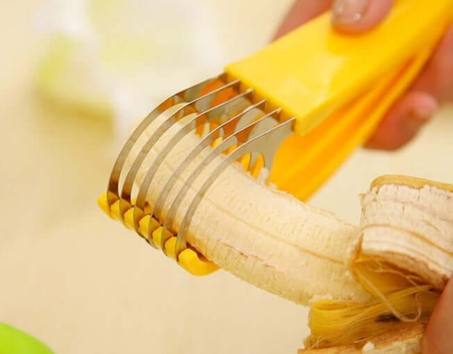 Yellow banana slicer cutting banana, kitchen utensil for fruit preparation