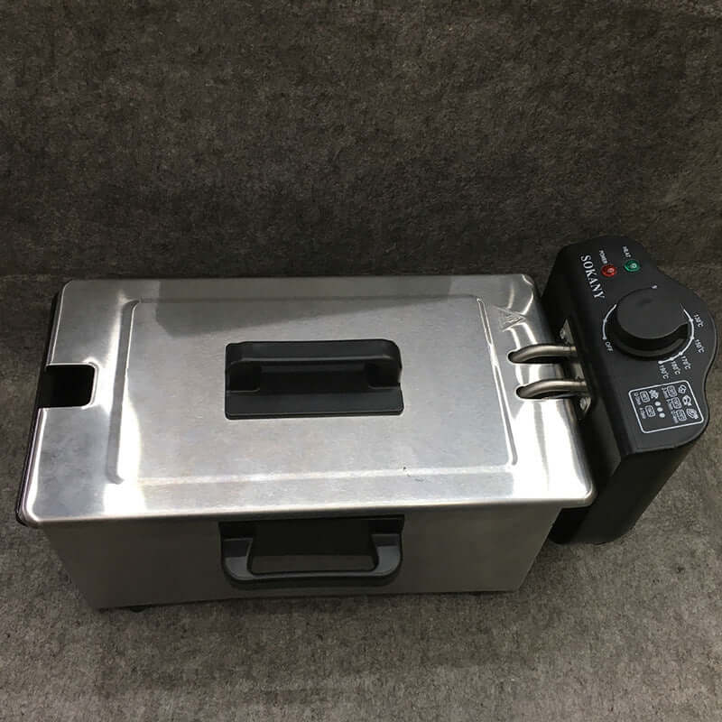 Stainless steel electric deep fryer with black control panel on grey background