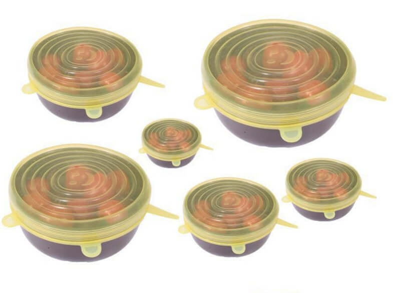 Set of silicone stretch lids covering bowls with food, reusable kitchen food storage covers