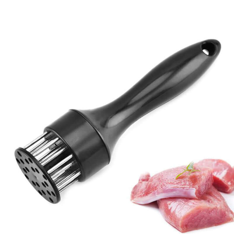 Black meat tenderizer tool with metal blades next to raw meat pieces on white background
