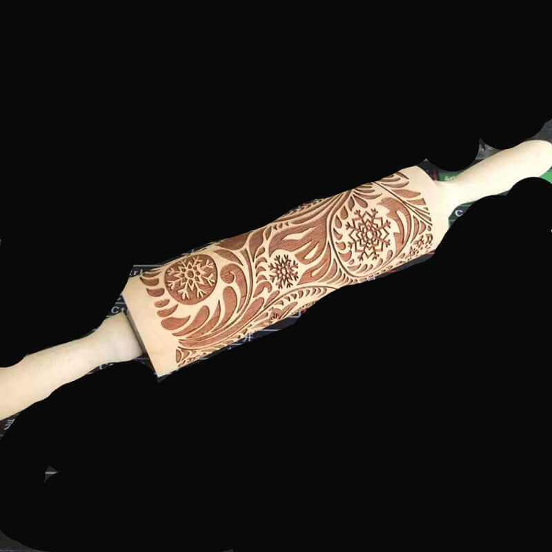 Wooden embossed rolling pin with intricate snowflake and floral patterns for baking