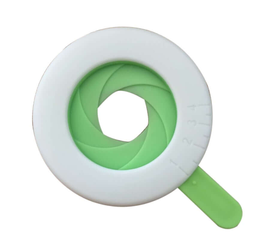 Adjustable green and white kitchen egg separator tool with handle, isolated on white background