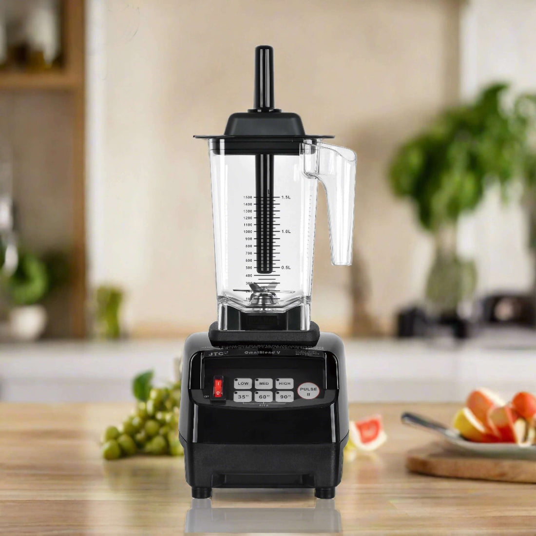 Countertop kitchen blender with control panel and clear pitcher in modern kitchen setting