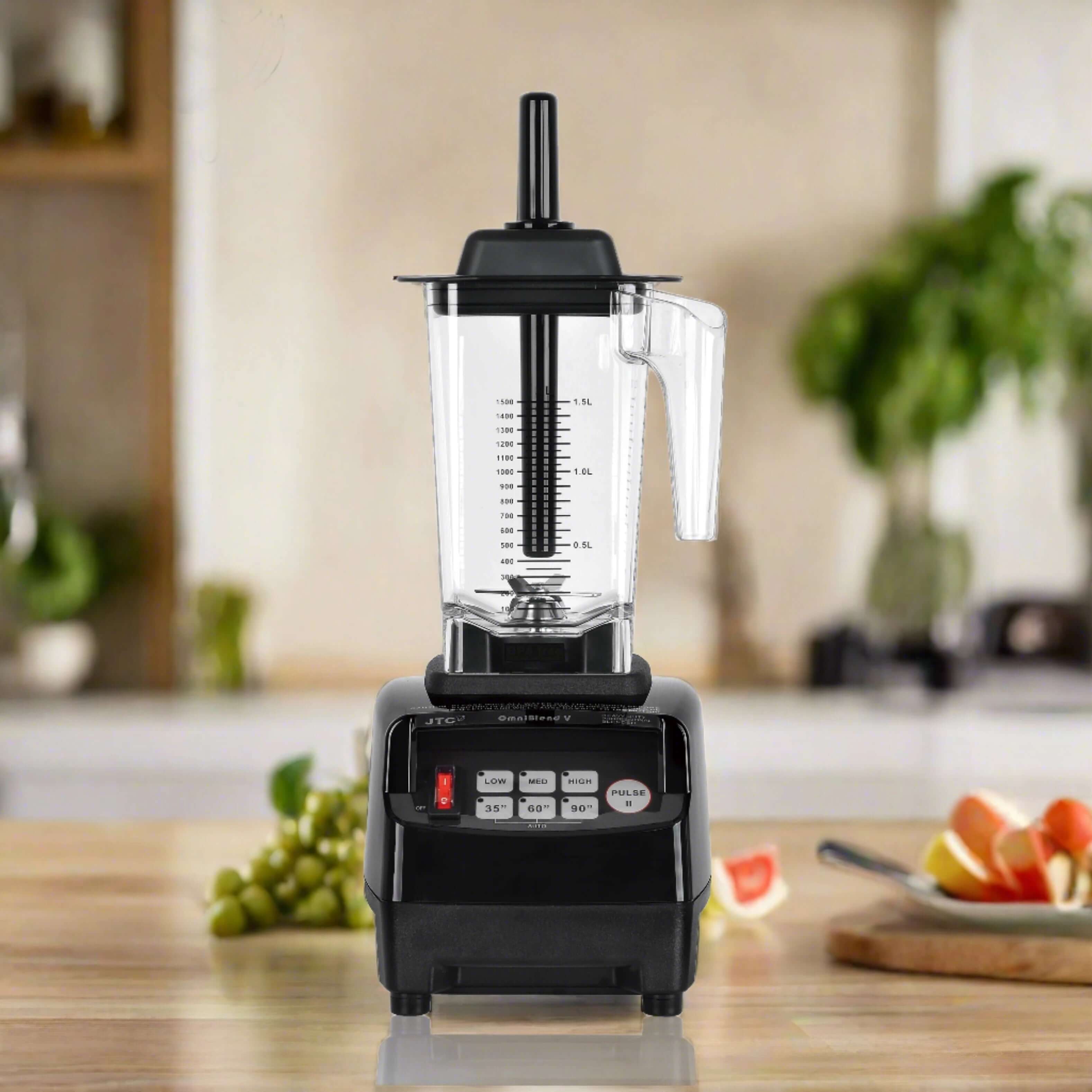 Countertop kitchen blender with control panel and clear pitcher in modern kitchen setting