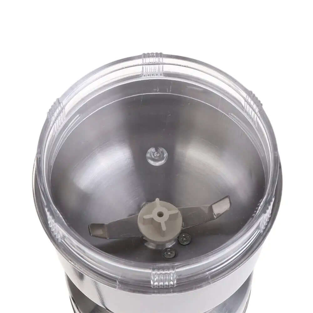 Top view of stainless steel electric grinder blender with sharp metal blades and clear lid