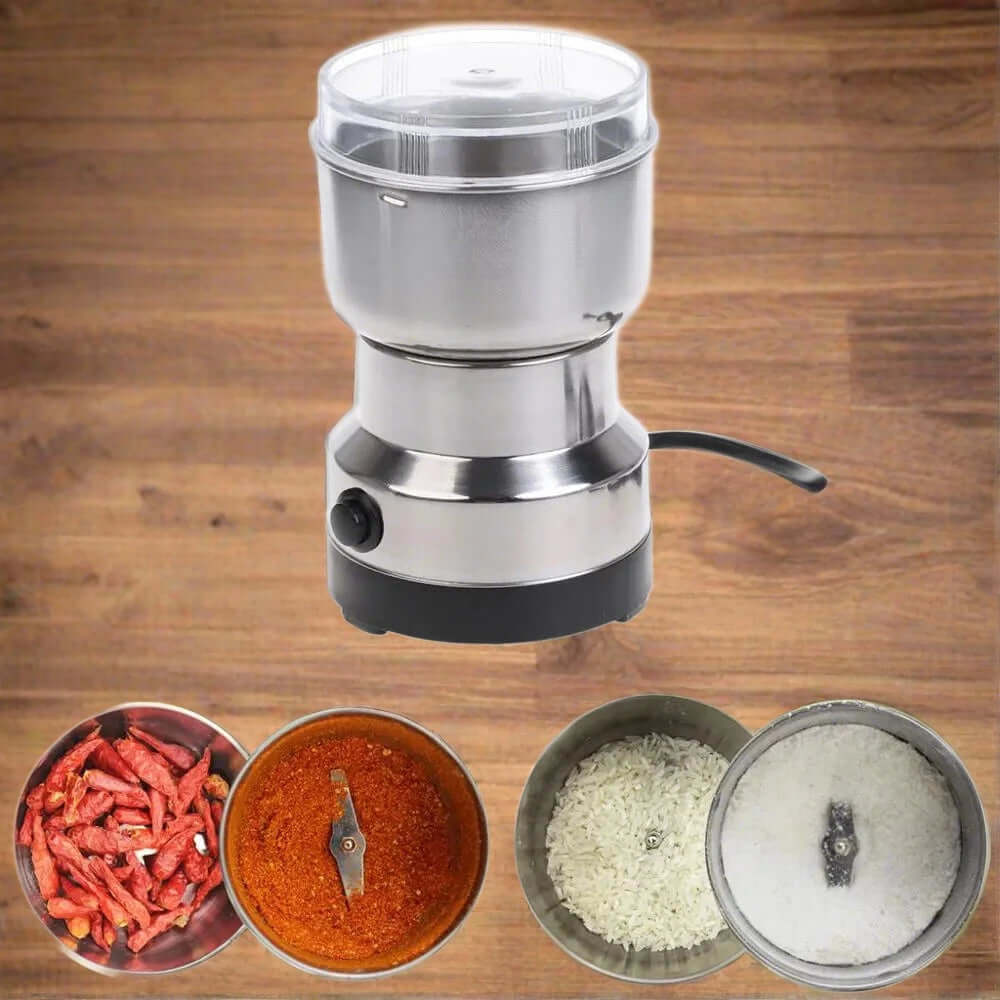 Stainless steel electric spice grinder with chopped chilies, ground spices, and rice on wood background