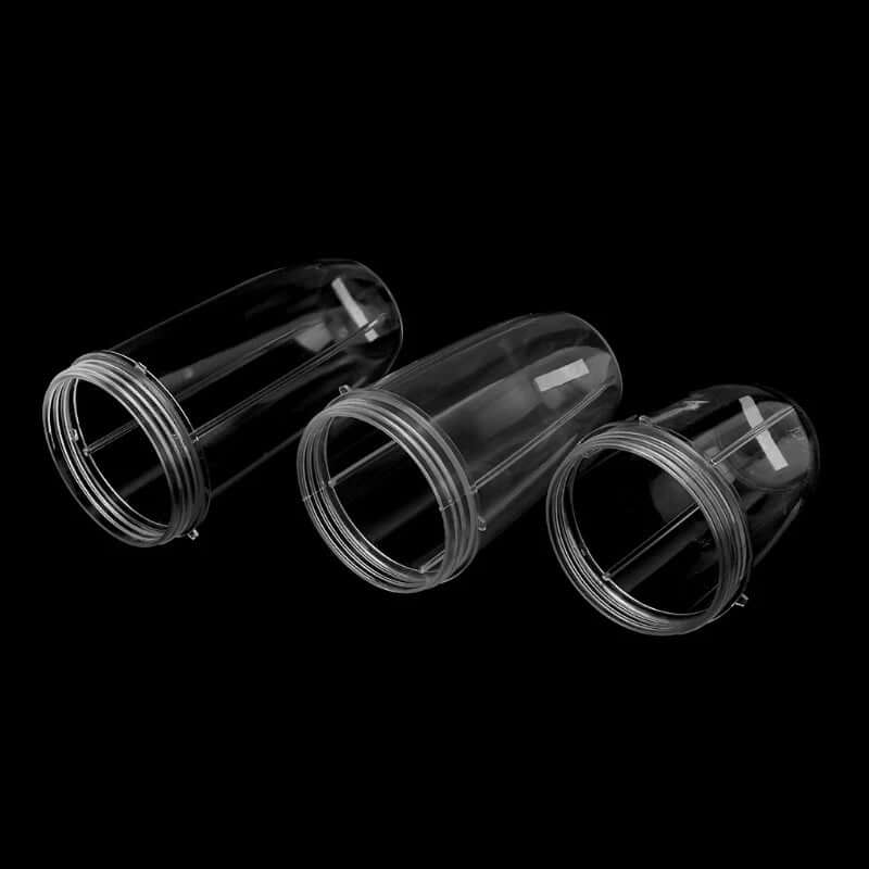 Set of three clear plastic blender cups for kitchen appliances, isolated on black background.