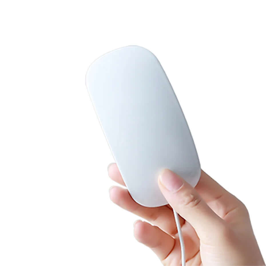 Hand holding a white, rectangular kitchen appliance with a cord on a white background