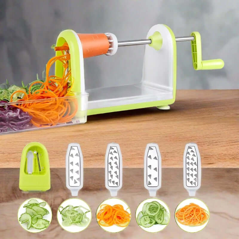 Manual vegetable spiralizer with multiple stainless steel blades on a wood counter, slicing carrots and cucumbers.