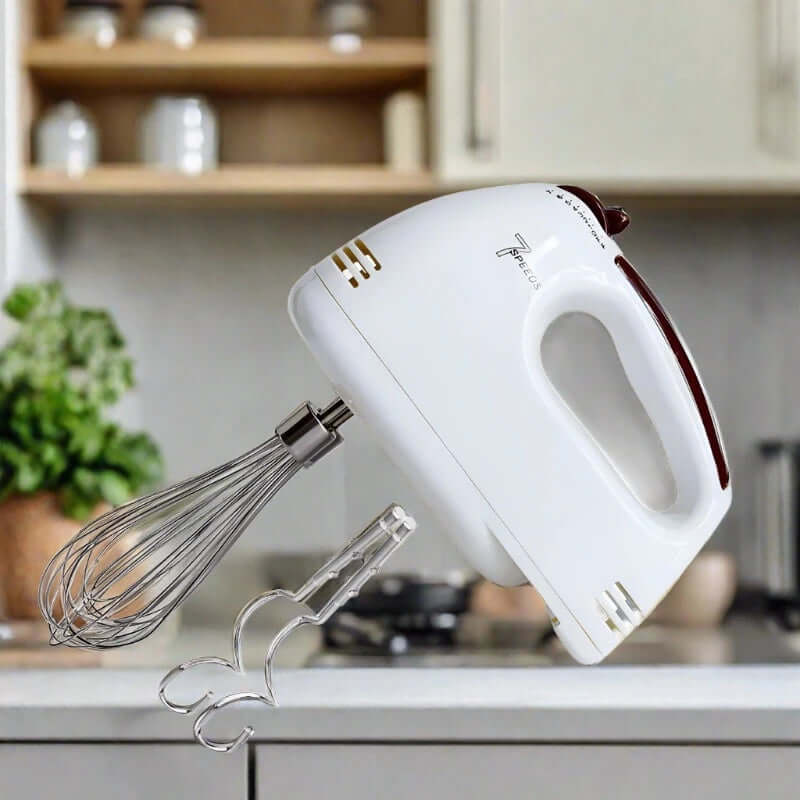 Electric hand mixer with stainless steel attachments in a modern kitchen setting