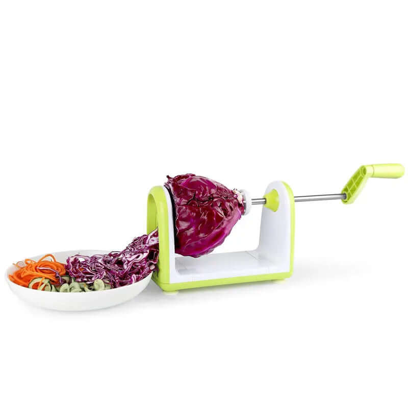 Vegetable spiralizer slicing red cabbage and vegetables into a white bowl