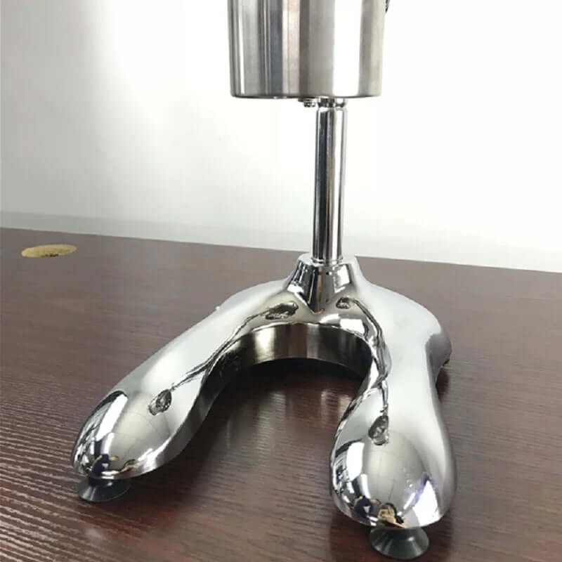 Stainless steel appliance base with suction feet on a wooden kitchen countertop