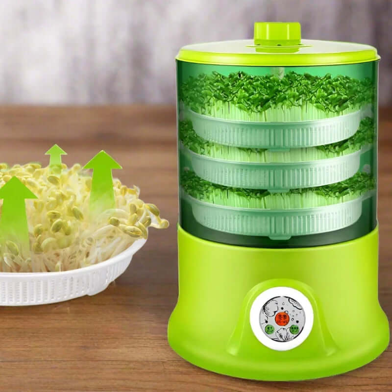 Green automatic sprout maker machine with stacked trays and fresh sprouts on wooden surface