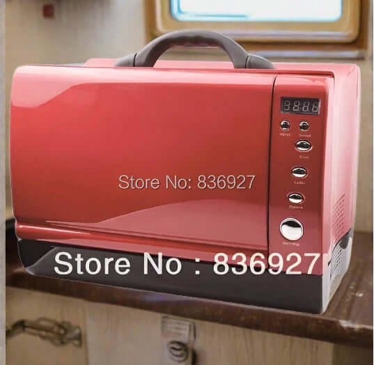 Compact red countertop dishwasher with digital controls in a kitchen setting