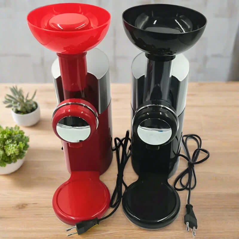 Red and black electric kitchen grinders on a wooden countertop with power cords