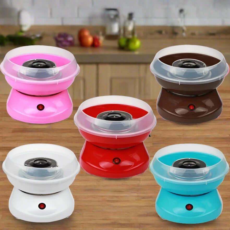 Five colorful countertop cotton candy makers on a wooden kitchen table