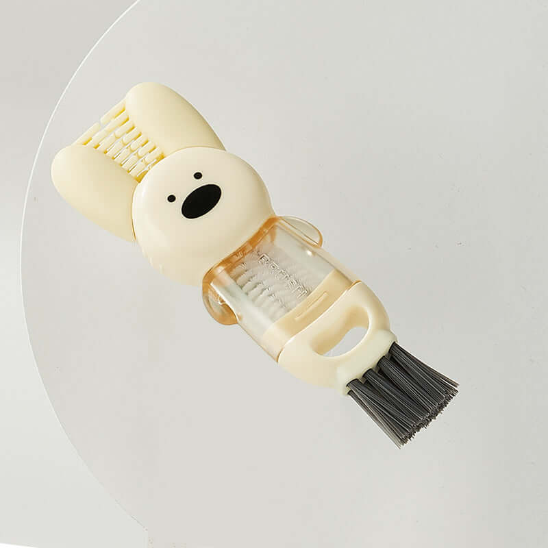 Cute animal-shaped kitchen cleaning brush with bristles and scraper, countertop background.