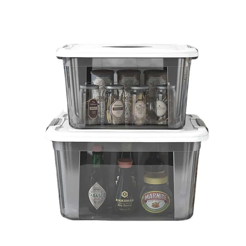 Clear plastic kitchen storage containers with white lids holding spice jars and condiment bottles
