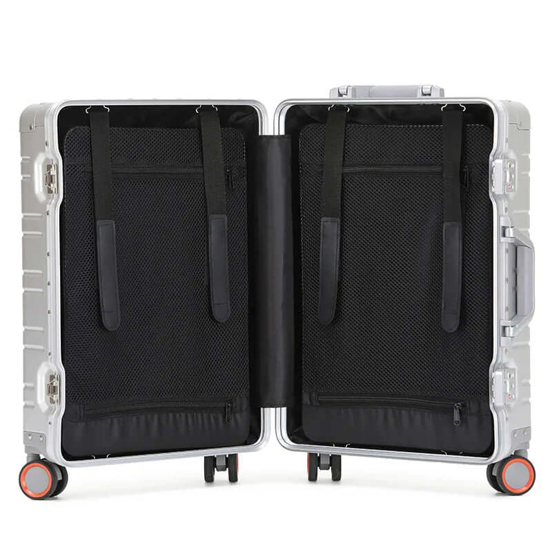 Open hard-shell suitcase with black mesh interior, compression straps, and wheels