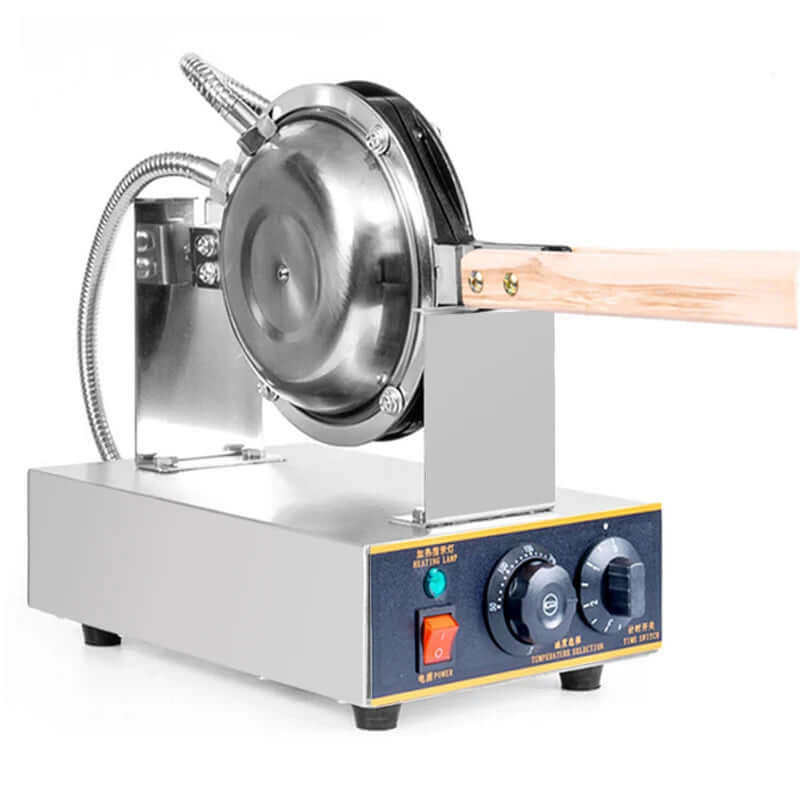 Electric waffle maker with stainless steel round plates and wooden handle on a kitchen appliance countertop