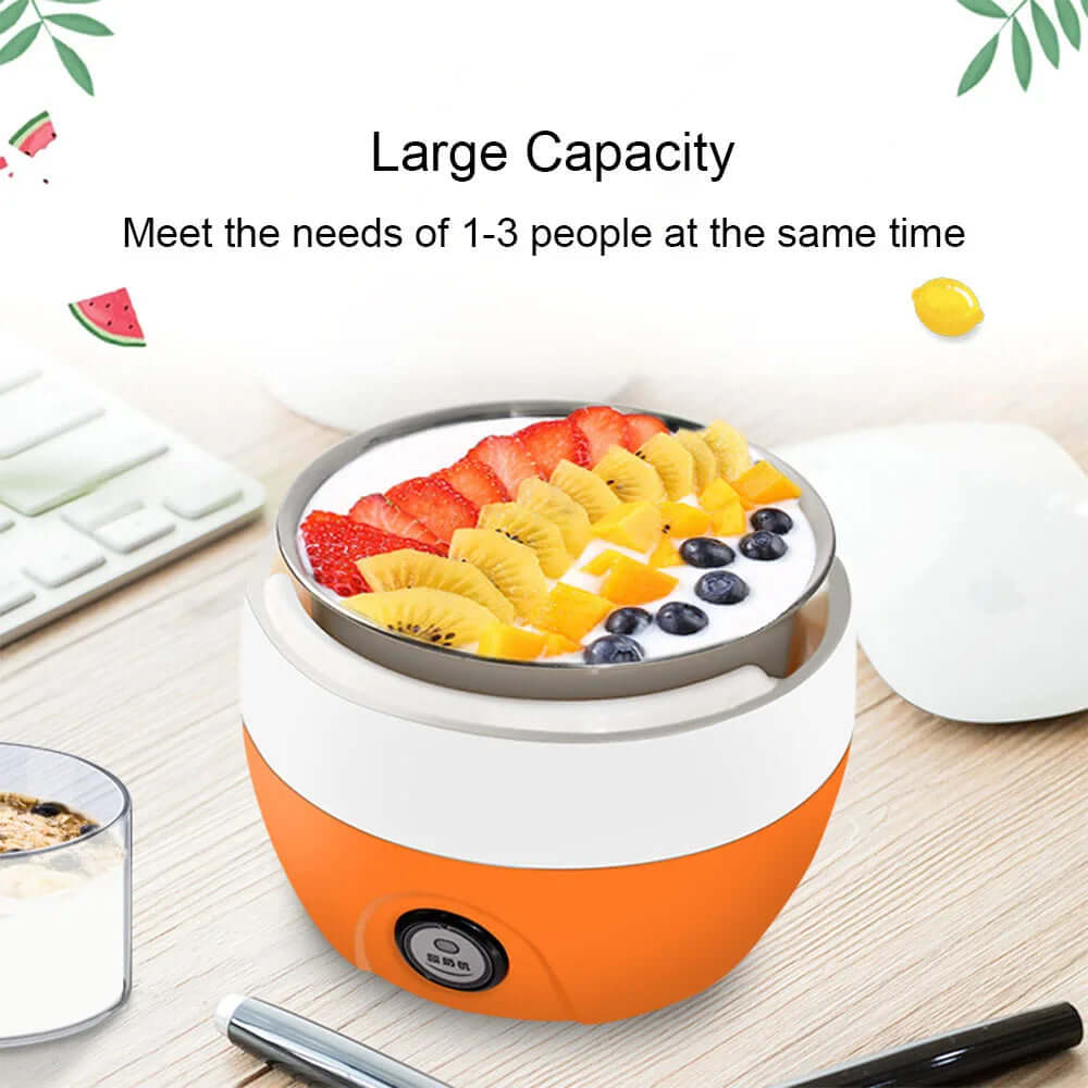 Orange electric yogurt maker with large bowl of yogurt topped with fresh fruit on a desk