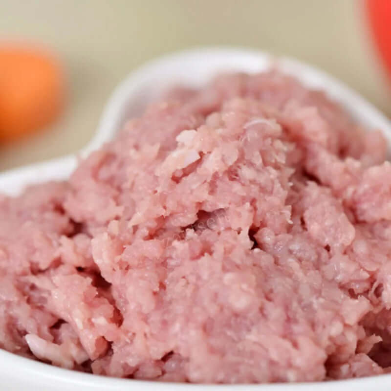 Fresh ground meat in a white bowl, close-up kitchen food ingredient