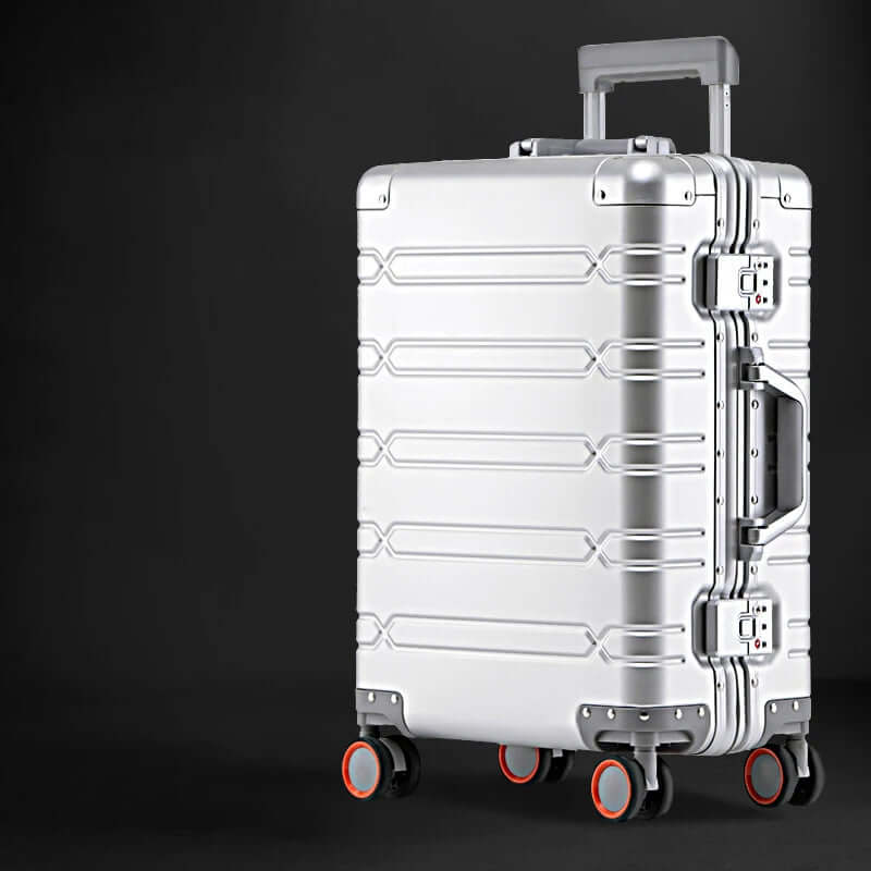 Silver hard-shell suitcase with four wheels and telescopic handle on black background