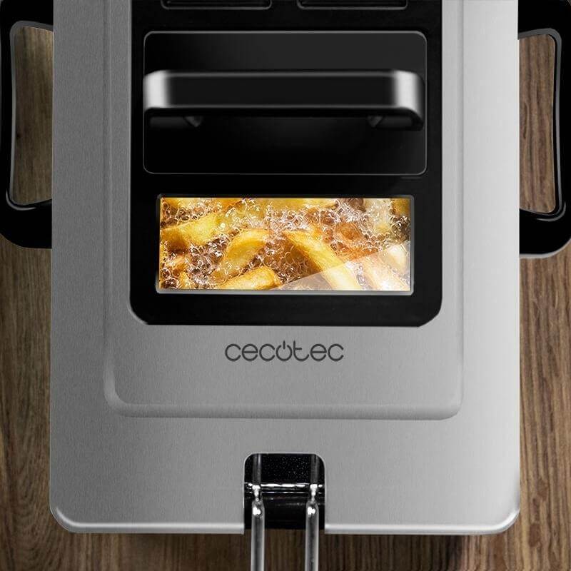 Overhead view of a deep fryer with fries frying inside, stainless steel kitchen appliance