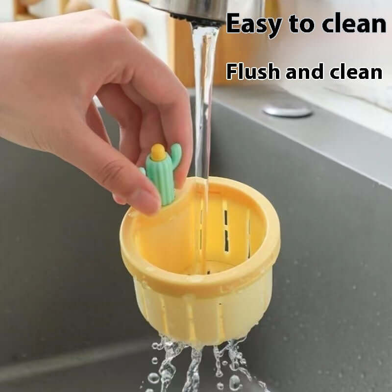 Hand washing yellow kitchen sink strainer basket with cactus handle under running water