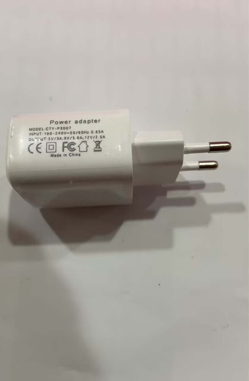 White power adapter with two round prongs, voltage and safety markings visible