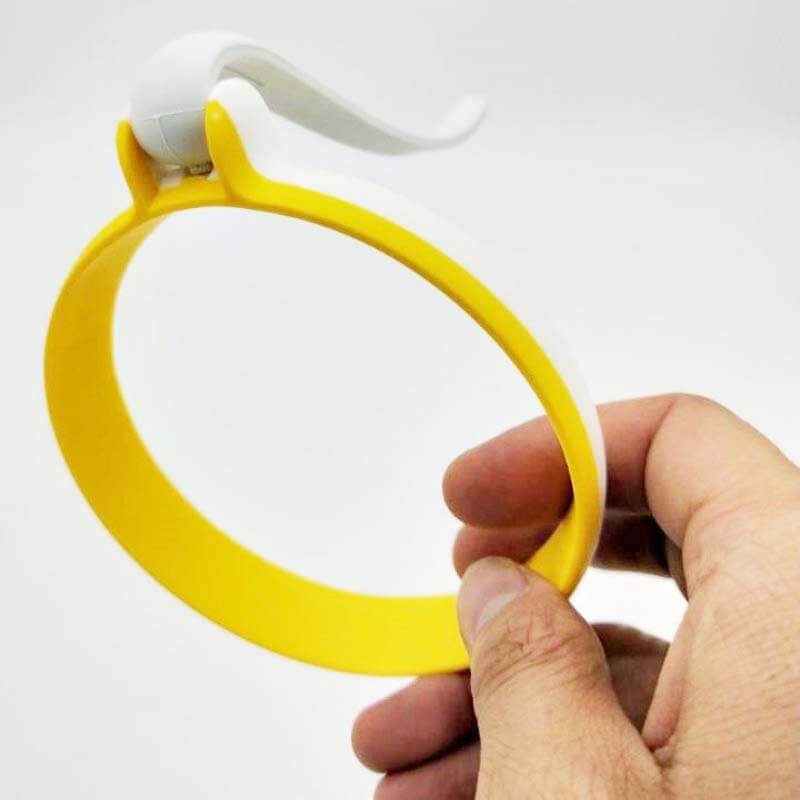 Hand holding a yellow and white kitchen jar opener tool against a plain background