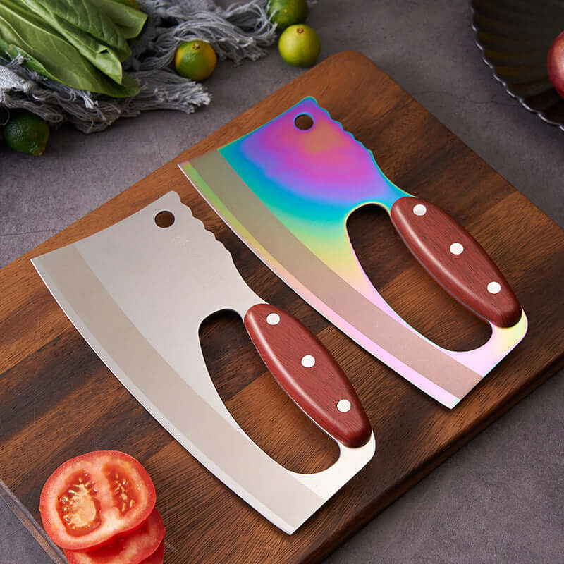 Two kitchen cleaver knives with wooden handles on a cutting board, one with a rainbow blade.