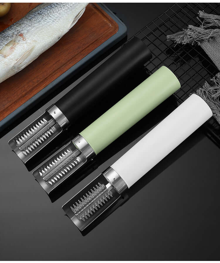 Three fish scale removers with black, green, and white handles on a kitchen countertop