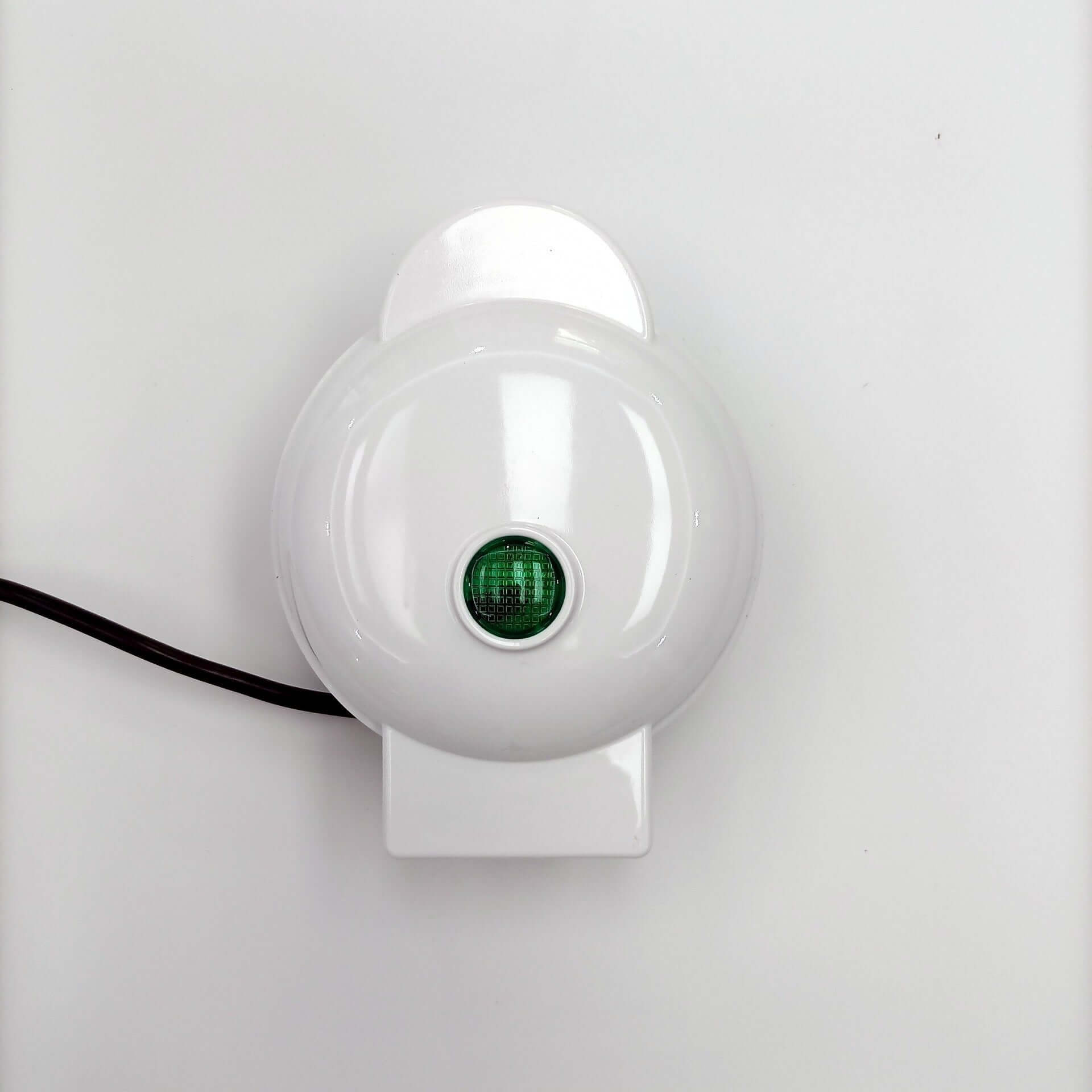 White kitchen appliance with green indicator light and black power cord on white background