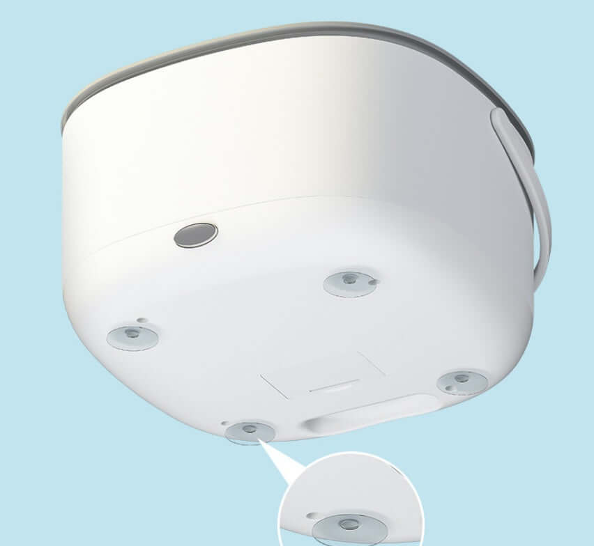 White kitchen container with suction cups on bottom, close-up view against blue background
