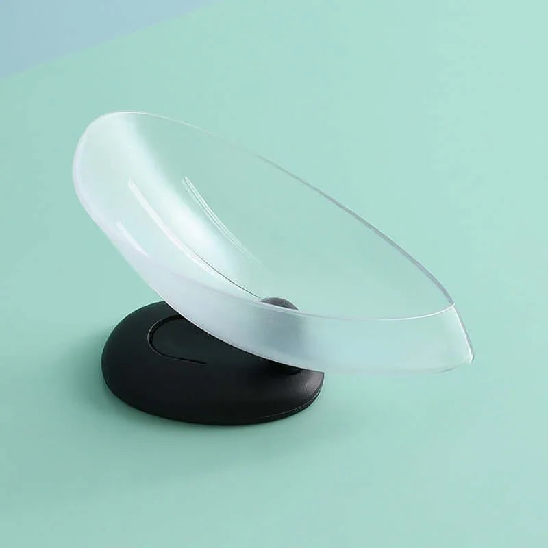 Clear plastic spoon rest with black base kitchen accessory on mint green background