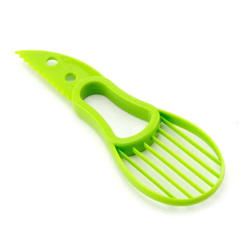 Green plastic avocado slicer and cutter kitchen tool on white background