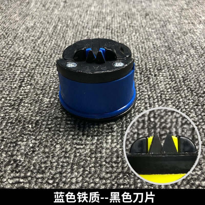 Blue and black kitchen knife sharpener with close-up of sharpening blades, on textured surface