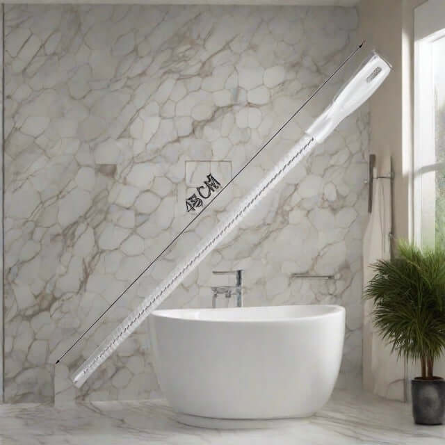 White kitchen cleaning brush with long handle beside sink on marble countertop