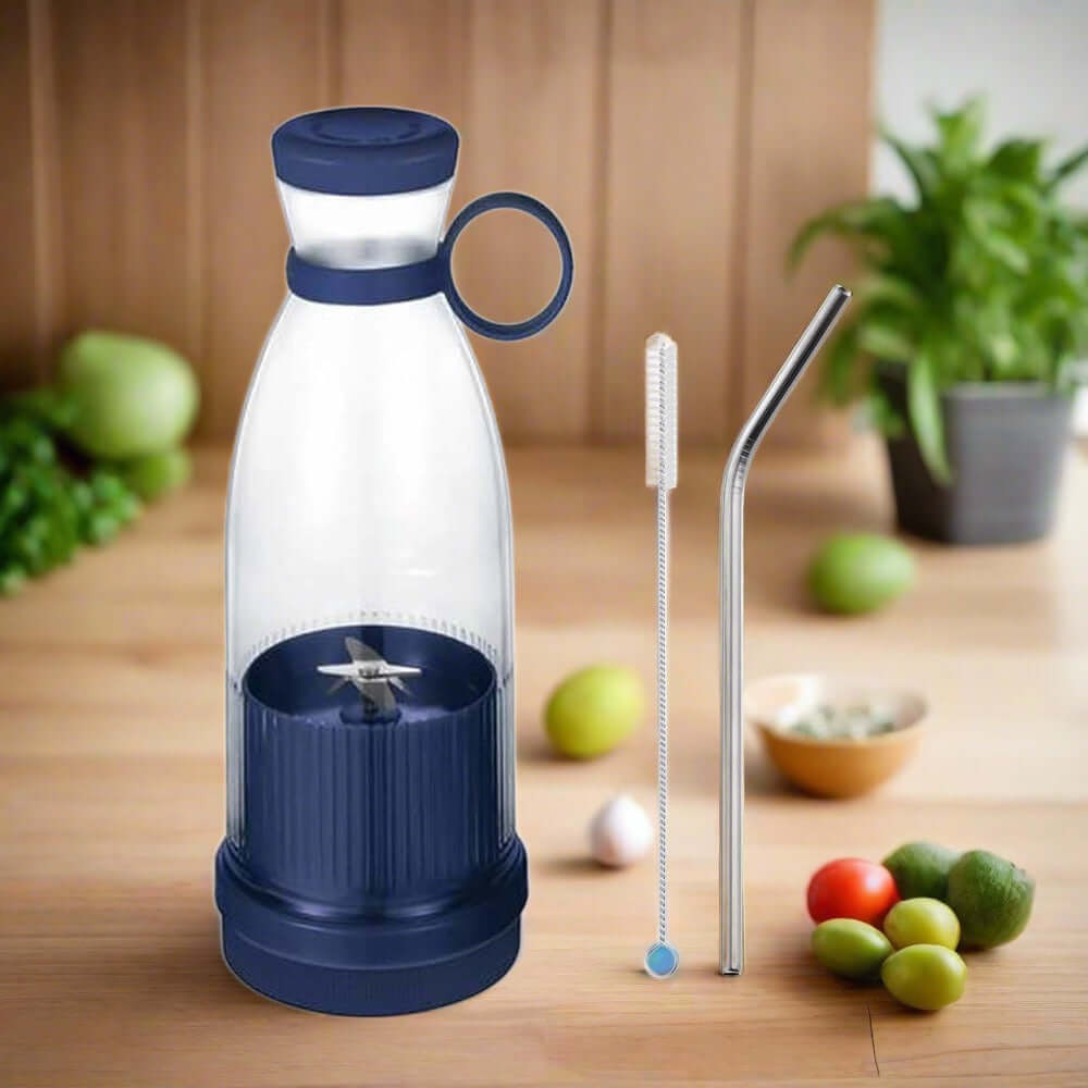 Portable blender bottle with blue lid, metal straw, and cleaning brush on kitchen counter
