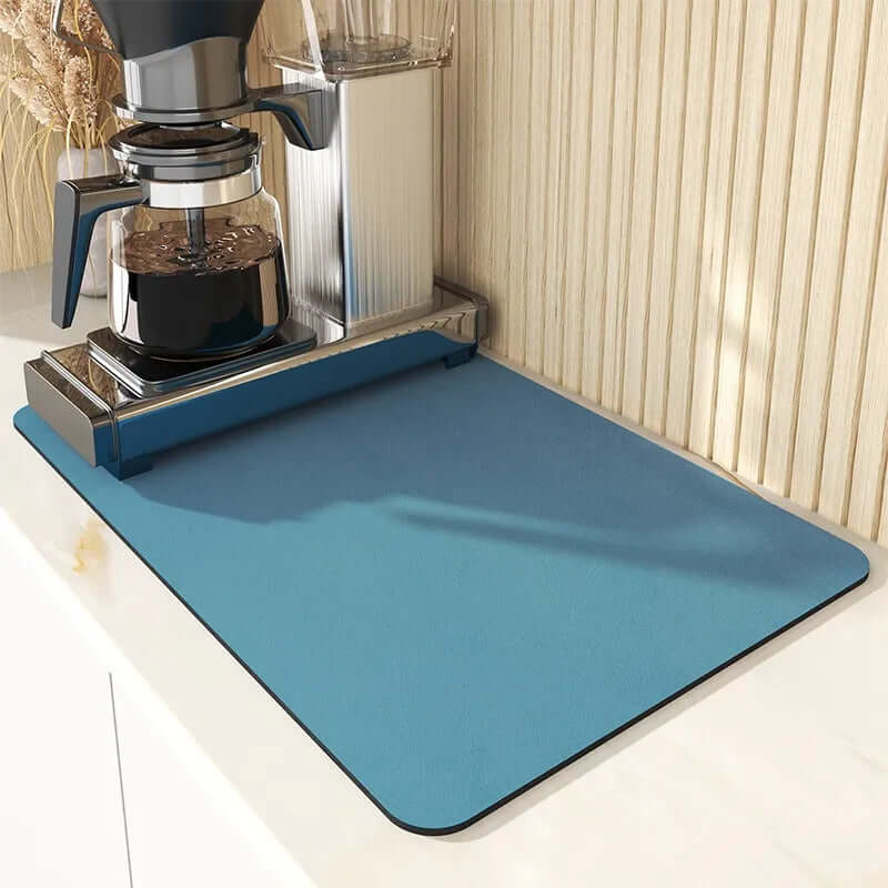 Blue kitchen countertop mat under coffee maker on white surface
