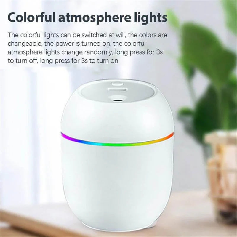 White LED humidifier with colorful atmosphere light on tabletop, indoor kitchen accessory