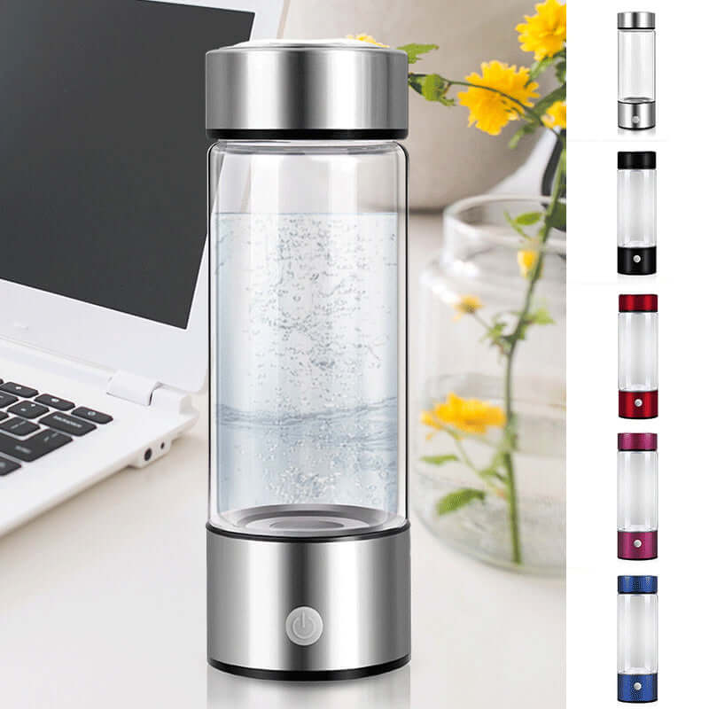 Portable hydrogen water bottle generator with stainless steel base, sitting on a desk near a laptop and flowers, available in multiple colors.