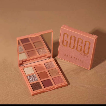 Peach-toned eyeshadow palette with mirror, featuring shimmer and matte shades, on brown background