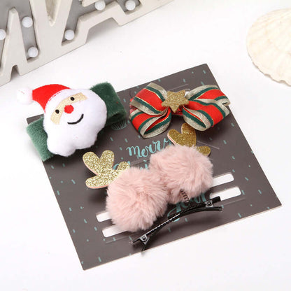 Christmas-themed hair clips with Santa, bow, and pink pom pom designs on display card