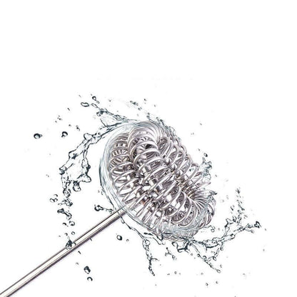 Stainless steel whisk attachment for hand mixer splashing in water, kitchen utensil cleaning